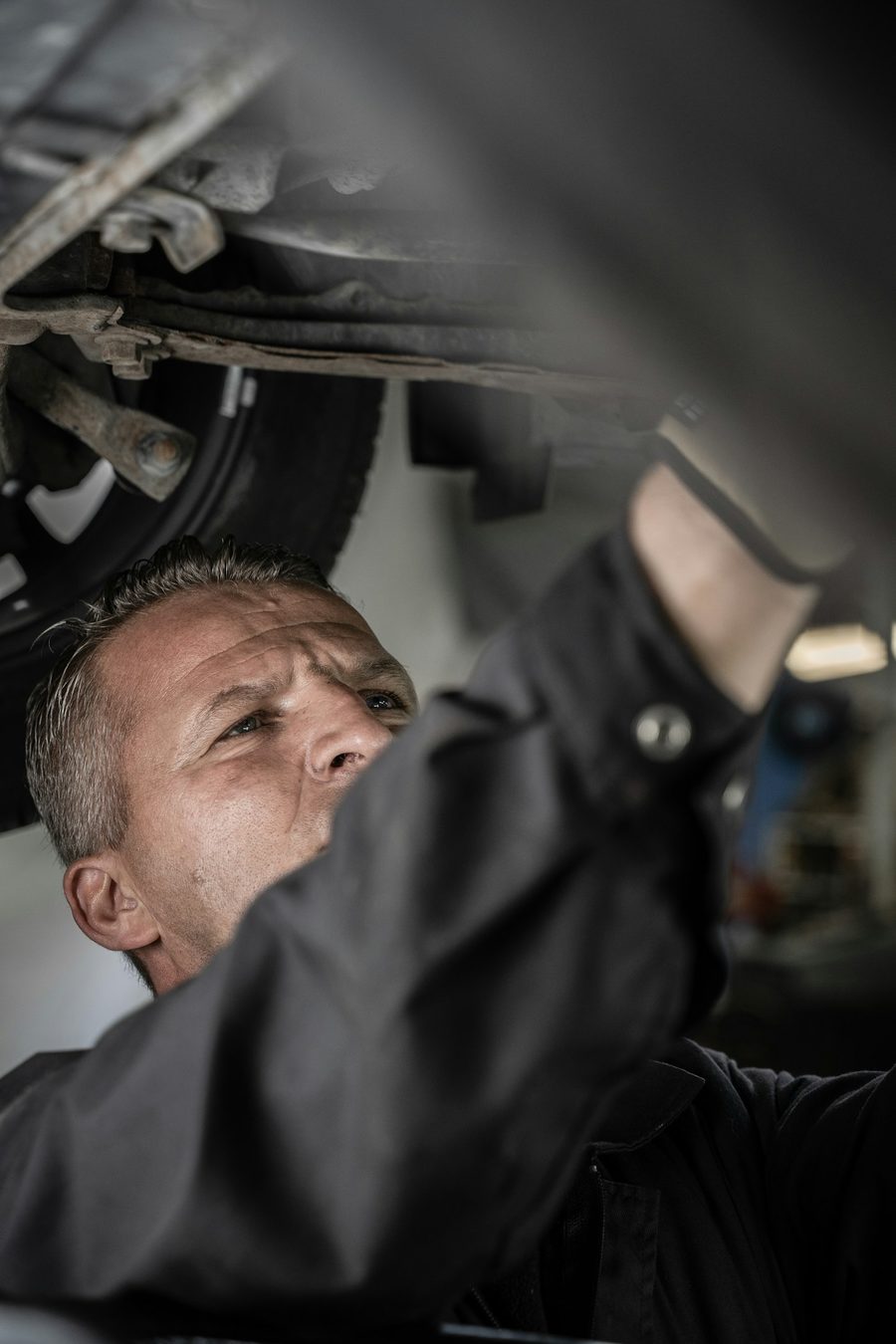 Technician working underneath a car